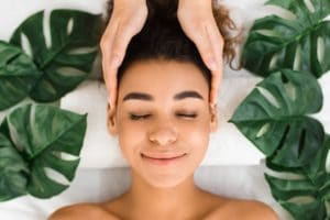 Head massage. Afro girl getting spa treatment