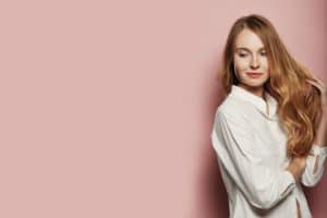 Pretty young woman posing on pink background