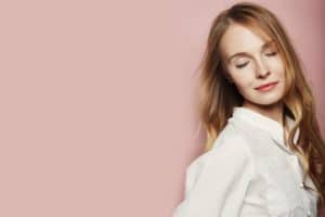 Pretty young woman posing on pink background