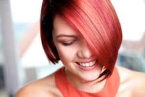 Pretty young woman smiling with eyes closed