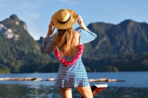 Young pretty blonde woman with long hairs posin on lake